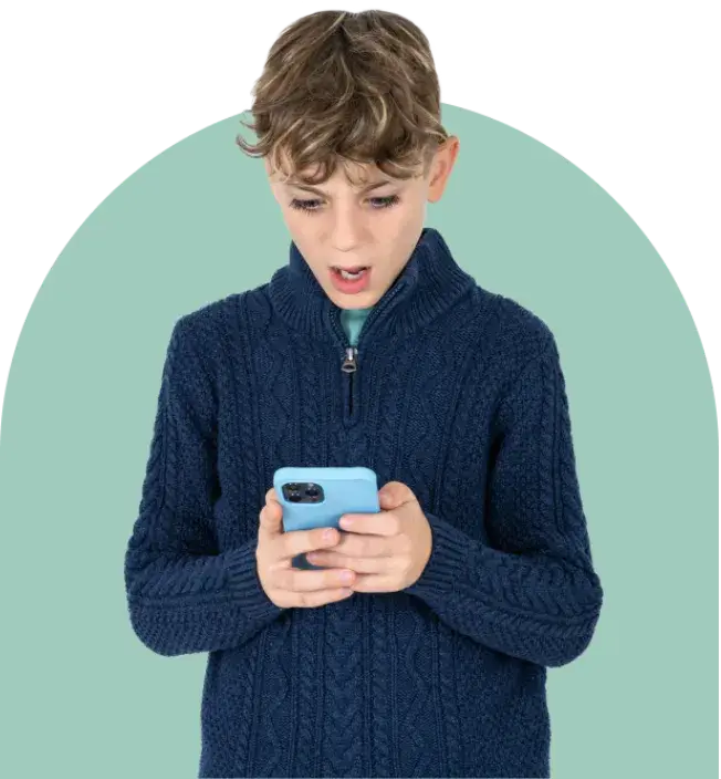 A young boy with curly hair, wearing a dark blue cable-knit sweater, looks surprised while holding a smartphone. The light teal background hints at the unexpected impact of screen time on his expression.