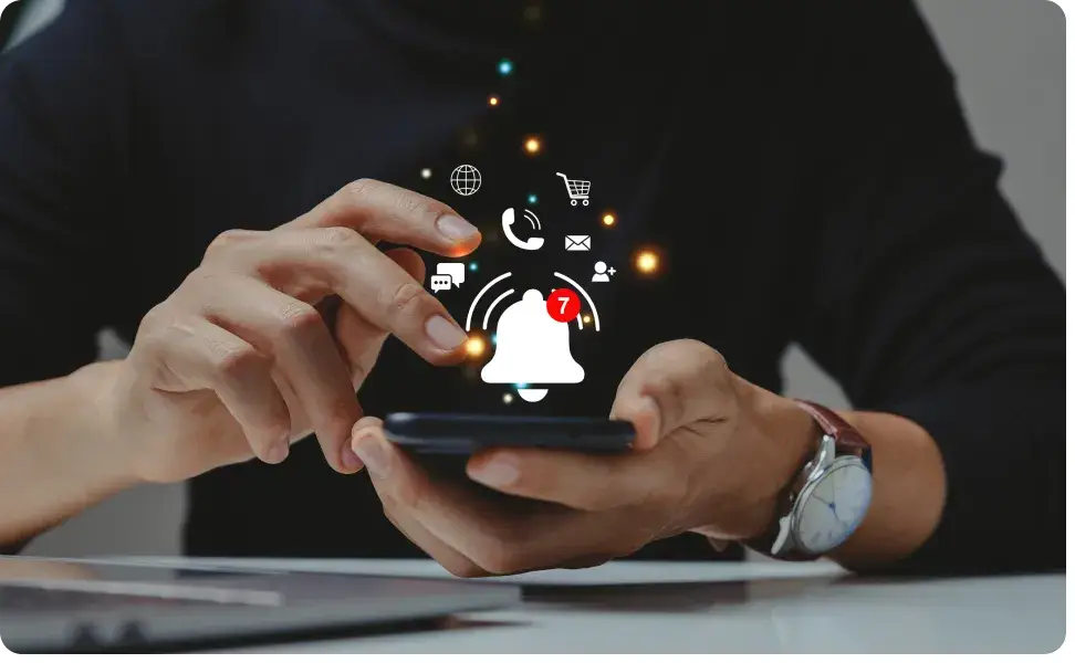 A person holding a smartphone buzzes with multiple notifications. Icons for email, calls, shopping, and messages appear above the phone. A bell icon shows seven new alerts, highlighting the impact of social media on teen mental health. The background is subtly blurred.