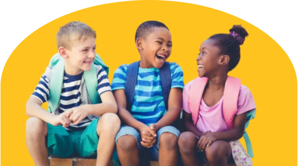 Three children are sitting and laughing together, wearing backpacks. They are dressed in colorful summer clothes against a bright yellow background. The setting suggests a playful and cheerful mood, possibly before or after school.